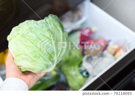 Men's hands taking cabbage out of the refrigerator for cooking Vegetable room 78118093