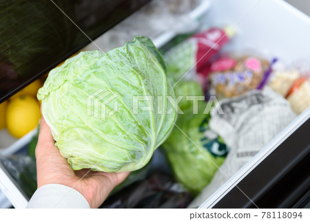 Men's hands taking cabbage out of the refrigerator for cooking Vegetable room 78118094