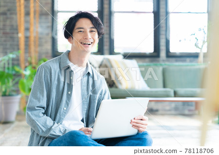 Men's living room telework remote work personal computer lifestyle 78118706