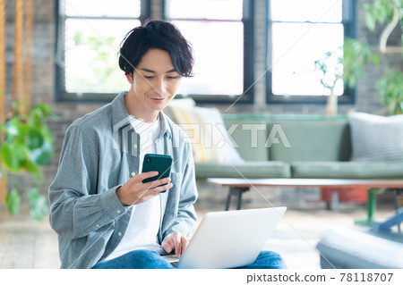 Men's living room telework remote work personal computer lifestyle 78118707