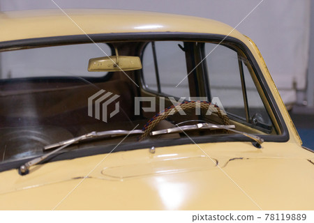 Old beige car. Braided steering wheel through the windshield. 78119889