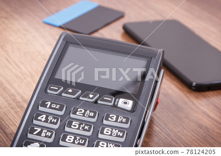 Payment terminal with credit card and mobile phone. Cashless paying for shopping. Finance concept 78124205