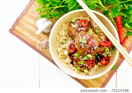 Meatballs in sweet and sour sauce with rice on board top Meatballs in sweet and sour sauce with rice on board top 78124396