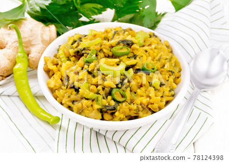 Kitchari with celery in bowl on board 78124398
