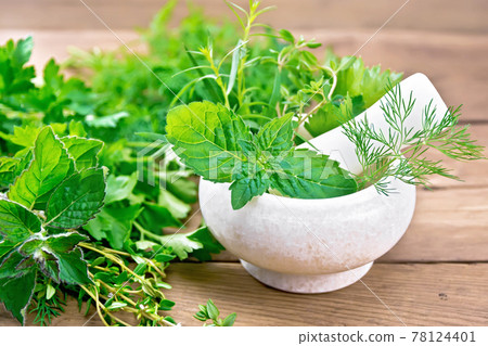 Herbs spicy in stone mortar on wooden board Herbs spicy in stone mortar on wooden board 78124401