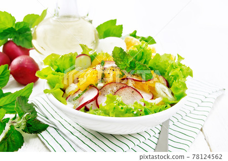 Salad of radish and orange with mint on board 78124562