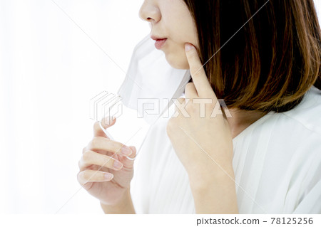 A woman who cares about rough skin of a mask A woman who cares about rough skin of a mask 78125256