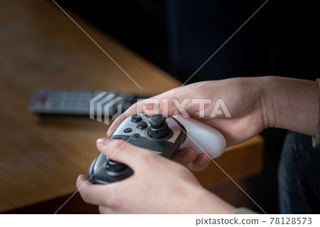 Hands of children playing video games Hands of children playing video games 78128573