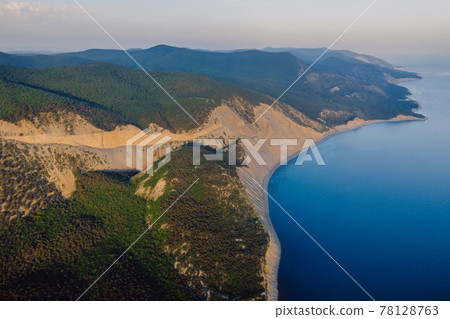 Aerial view of coastline with sea, mountains, canyon and cliffs with evening light. Aerial view of coastline with sea, mountains, canyon and cliffs with evening light. 78128763