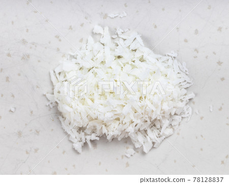 pile of coconut flakes close up on gray 78128837