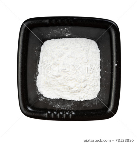 top view of baking powder in black bowl isolated 78128850