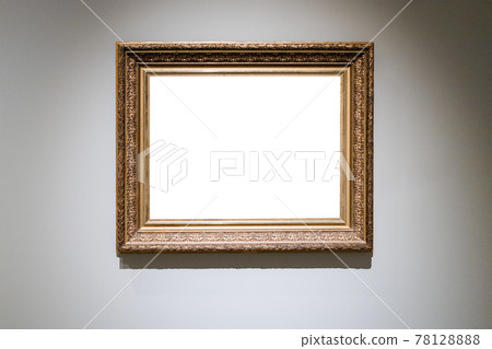 old carved wide wooden picture frame on gray wall 78128888