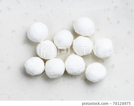 several raw tapioca pearls close up on gray several raw tapioca pearls close up on gray 78128975
