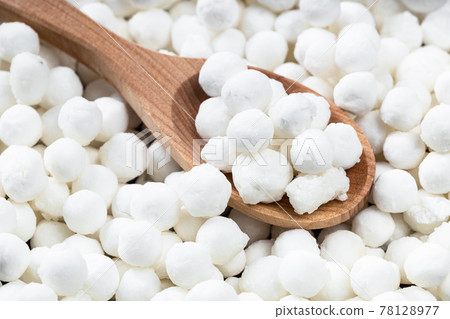 above view of wooden spoon with raw tapioca pearls above view of wooden spoon with raw tapioca pearls 78128977