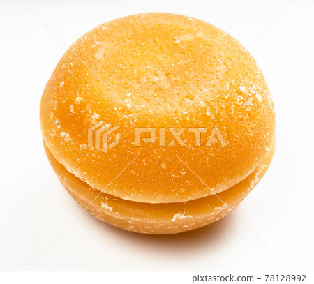 pair of whole round pieces of palm sugar on gray 78128992