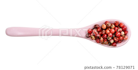 top view of ceramic spoon with pink peppercorns 78129071