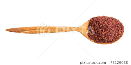 top view of wood spoon with ground sumac isolated top view of wood spoon with ground sumac isolated 78129088