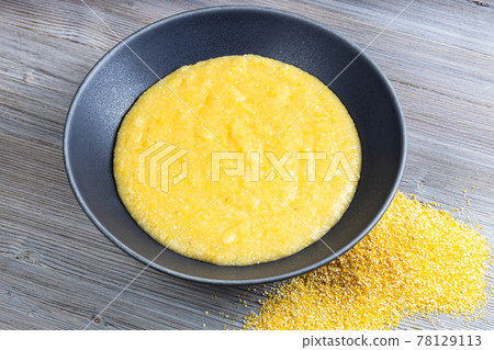cooked maize porridge and handful of cornmeal cooked maize porridge and handful of cornmeal 78129113