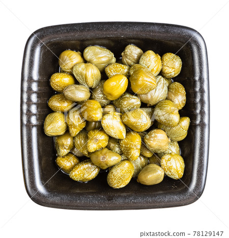 top view of pickled capers in black bowl isolated top view of pickled capers in black bowl isolated 78129147
