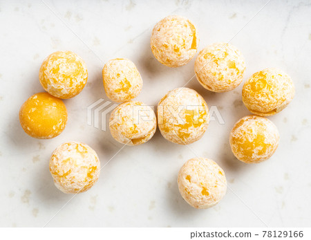 several dried whole yellow peas close up on gray 78129166