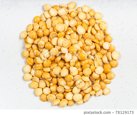 pile of dried split yellow peas close up on gray pile of dried split yellow peas close up on gray 78129173