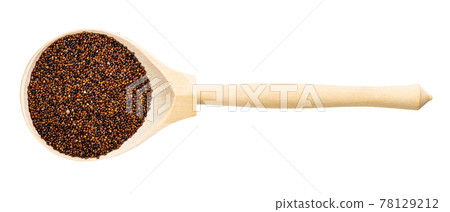 top view of wood spoon with raw canihua grains 78129212