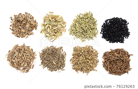 piles of various caraway like fruits on white 78129263