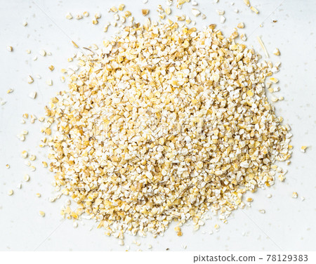 pile of crushed pot barley groats close up on gray pile of crushed pot barley groats close up on gray 78129383