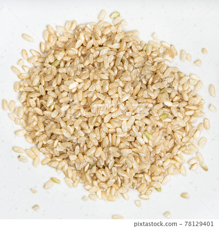 pile of unpolished brown rice close up on gray pile of unpolished brown rice close up on gray 78129401