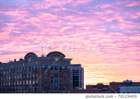 purple and yellow cloudscape over apartment houses 78129409