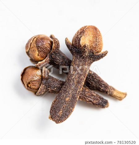few whole dried cloves close up on gray 78130520