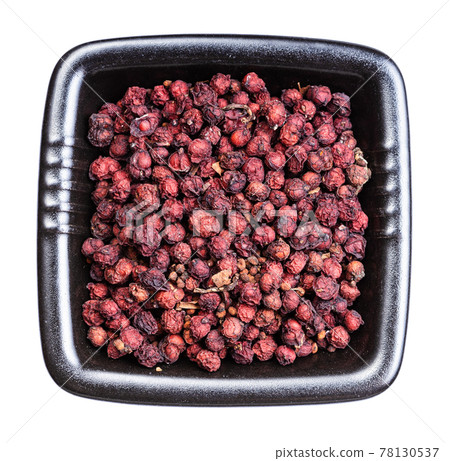 dried magnolia berries in black bowl isolated 78130537
