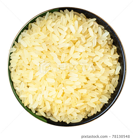 raw parboiled rice in round bowl isolated 78130548