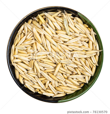 unhulled common oat grains in round bowl isolated unhulled common oat grains in round bowl isolated 78130570