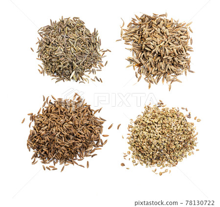 top view of various cumin like seeds on white top view of various cumin like seeds on white 78130722