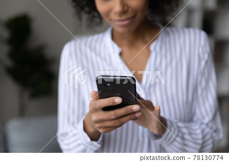 Close up of African American woman use cellphone Close up of African American woman use cellphone 78130774