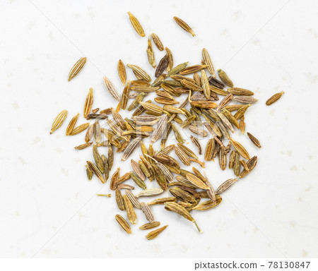 pinch of cumin (cuminum cyminum) seeds close up pinch of cumin (cuminum cyminum) seeds close up 78130847