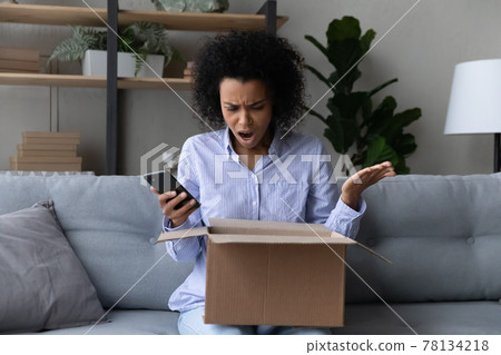 Unhappy biracial woman frustrated with bad quality order Unhappy biracial woman frustrated with bad quality order 78134218