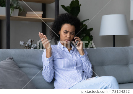 Unhappy African American woman have unpleasant cell call 78134232