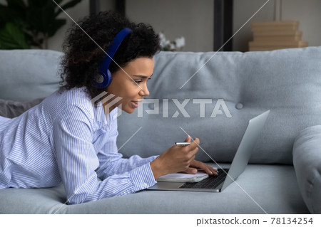 Biracial female student study on laptop at home Biracial female student study on laptop at home 78134254