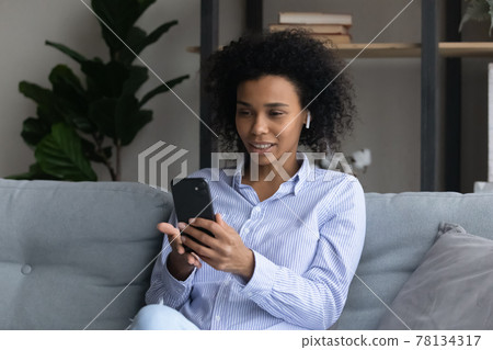 Biracial woman talk on video call on cellphone 78134317