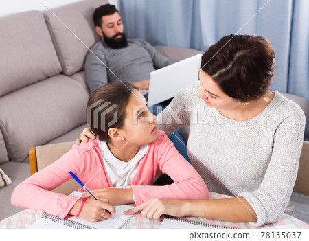 Mother helping daughter with homework Mother helping daughter with homework 78135037