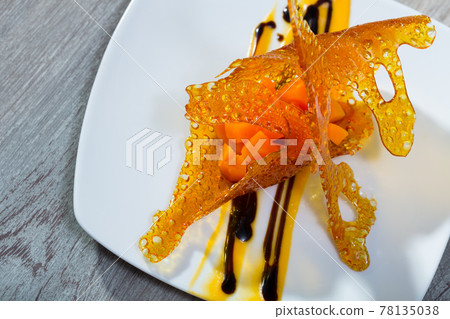 Tasty dessert of sweet carrots cubes with caramel and vanilla sauce Tasty dessert of sweet carrots cubes with caramel and vanilla sauce 78135038