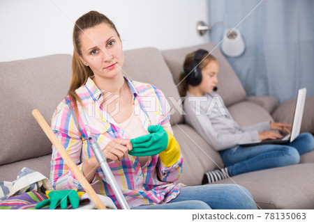 Tired mother sitting with mop Tired mother sitting with mop 78135063