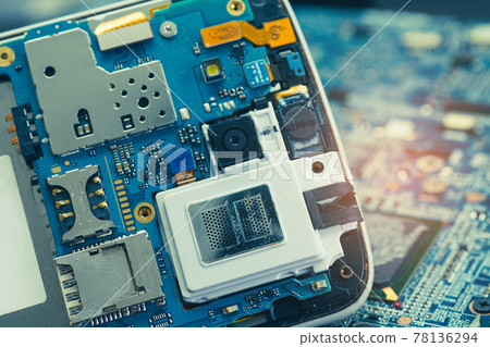 Technician repairing inside of mobile phone by soldering iron. Integrated Circuit. the concept of data, hardware, technology. 78136294