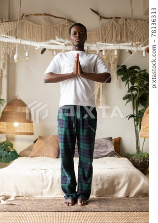 African man working out, yoga, pilates, fitness training, basic standing asana tadasana, mountain yoga posture African man working out, yoga, pilates, fitness training, basic standing asana tadasana, mountain yoga posture 78136313