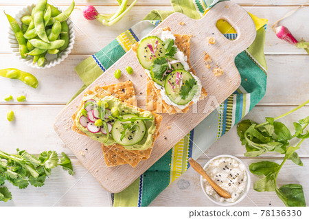 Healthy eating concept - crisp breads with cucumber and raddish on white background 78136330