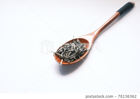 green tea dry leafs on spoon on white green tea dry leafs on spoon on white 78136362