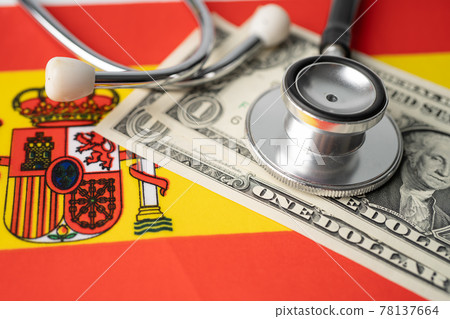 Black stethoscope on Spain and US dollar banknotes flag background, Business and finance concept. Black stethoscope on Spain and US dollar banknotes flag background, Business and finance concept. 78137664