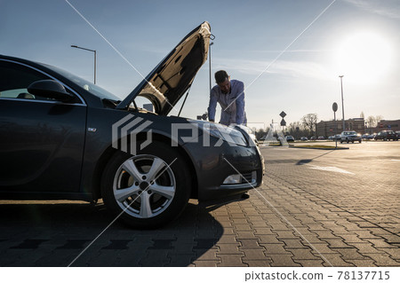 Car broken down. Driver man near open hood auto. Vehicle motor problem concept. 78137715